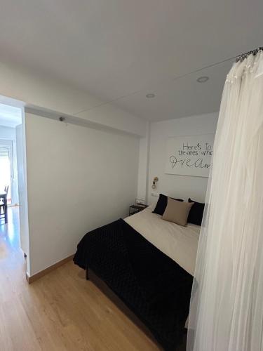 a bedroom with a bed in a white room at Corazón de Nerja in Nerja