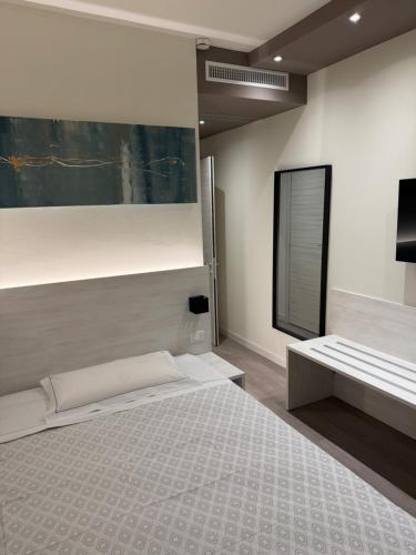 a bedroom with a large bed and a mirror at Confidence Hotel Suzzara in Suzzara
