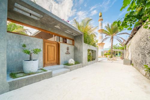 an exterior view of a house with a mosque at Villa Lumora Maldives in Rasdhoo
