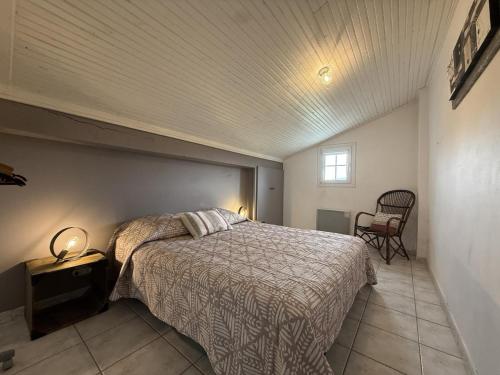 a bedroom with a bed and a chair in a room at Axuri-alde in Sare