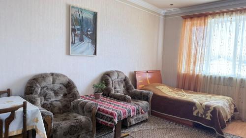 a living room with two chairs and a table at sweet home in Sevan
