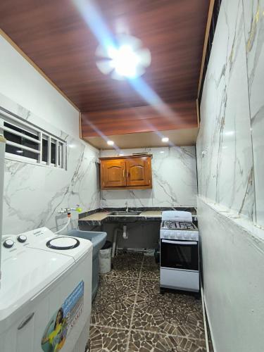 a small kitchen with a sink and a stove at Frontera Stay Don Pinto in Canoa Abajo