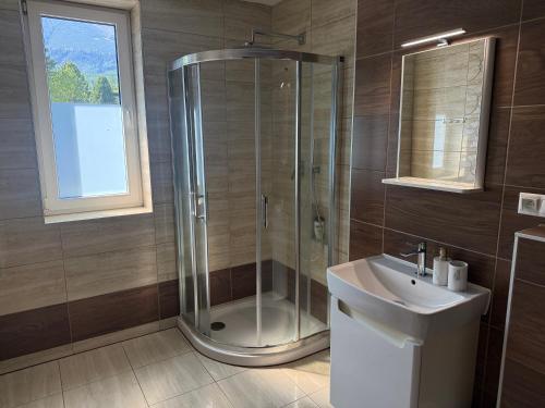 a bathroom with a shower and a sink at Quota 850 in Tatranská Lomnica