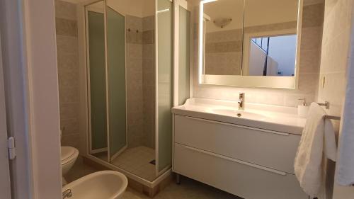 a bathroom with a sink and a shower and a toilet at Cupola Blu in Ragusa