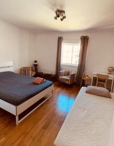 a bedroom with two beds and a window at The Throne in Alcabideche