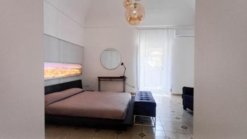 a bedroom with a bed and a mirror on the wall at Cupola Blu in Ragusa