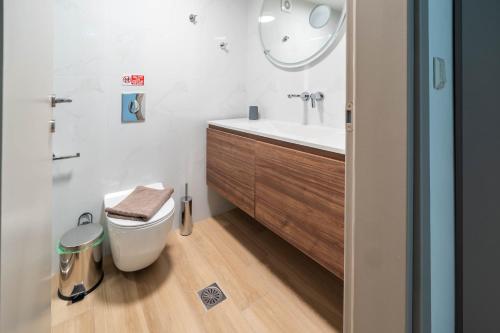 a bathroom with a toilet and a sink at The Olive Path in Kalandra