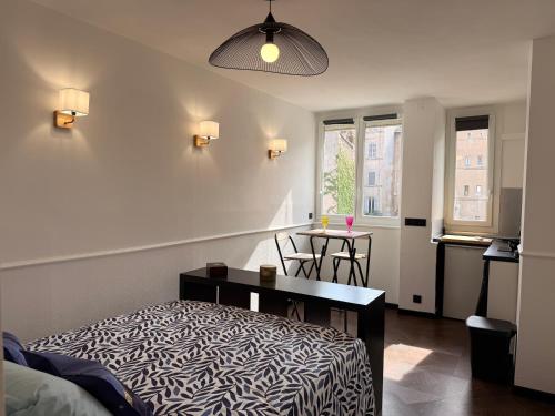 a bedroom with a bed and a table and chairs at Studio hyper centre in Marseille