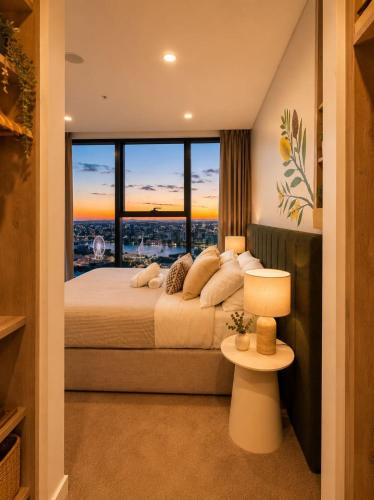 a bedroom with a large bed with a large window at Koala Sky Suite River & City Views in Brisbane