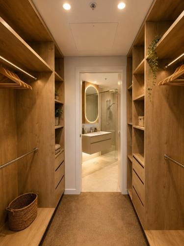 a bathroom with a walk in shower and a sink at Koala Sky Suite River & City Views in Brisbane
