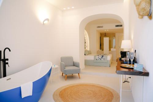 a bathroom with a bath tub and a bedroom at Il Borghetto Resort & Spa in Tropea