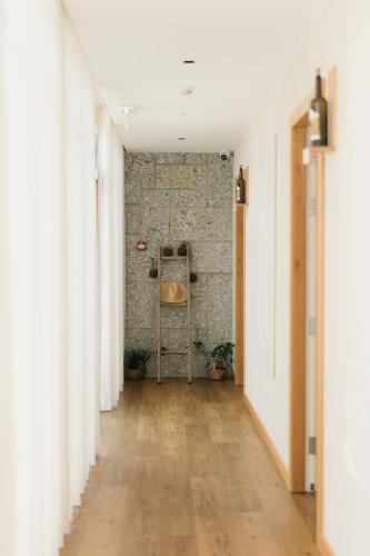 an empty hallway with white walls and a wooden floor at Constance Retreat - Douro Verde by FERO in Constance