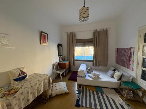 a living room with a bed and a couch at Studio coeur tanger in Tangier
