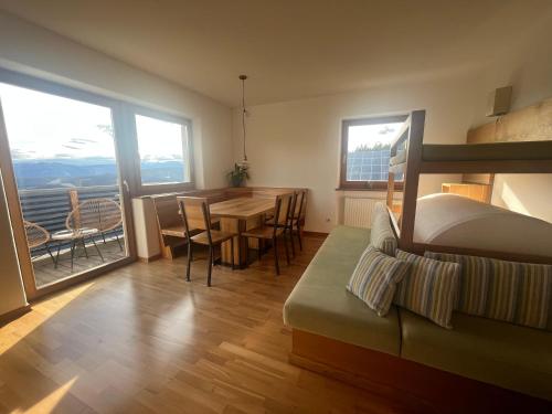 a living room with a table and a dining room at greenlodge pornplatthof in Auna di Sopra