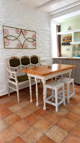 a wooden table and two chairs in a room at Est 1852 Andros - Tower 2 in Lámira