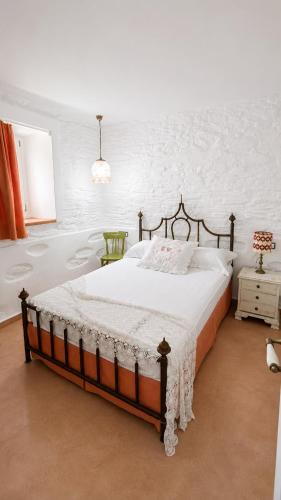 a bedroom with a large bed in a white room at Est 1852 Andros - Tower 2 in Lámira