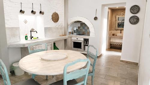 a kitchen with a wooden table and chairs in a room at Est 1852 Andros - Tower 1 in Lámira