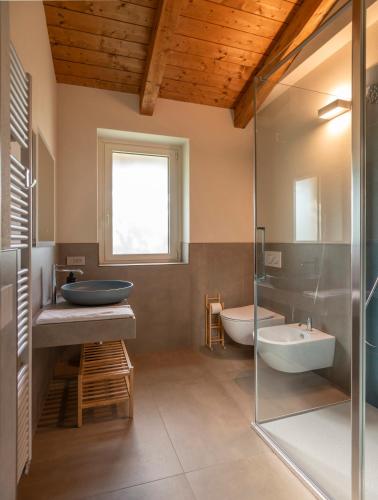 a bathroom with a sink and a tub and a shower at Radici in Serralunga d'Alba
