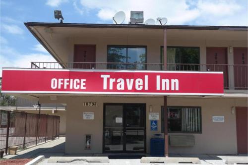 an office travel inn with a red sign on it at Travel Inn By OYO Omaha in Millard