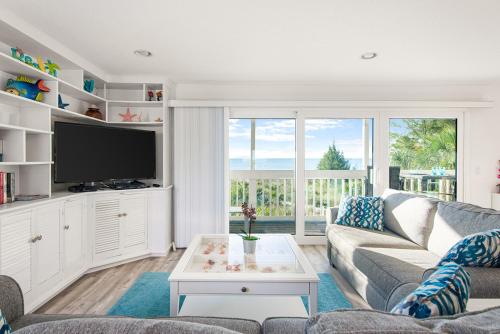 a living room with a couch and a tv at Escape Coastal Resort on Casey Key in Nokomis