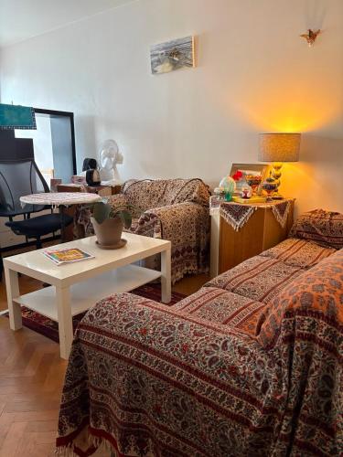 a hotel room with two beds and a table at DREAM Flat in PARIS in Levallois-Perret