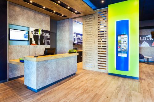 an office lobby with a reception counter and a desk at Ibis Budget Mulhouse Centre Gare in Mulhouse