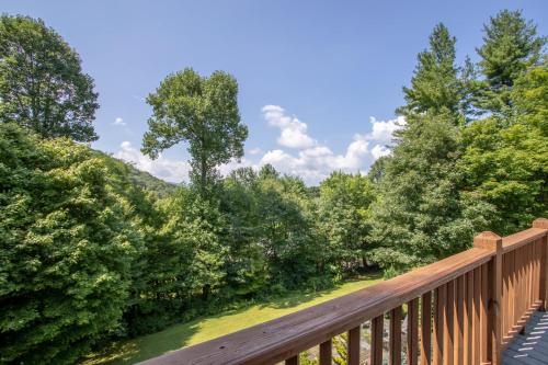 a wooden bridge over a forest of trees at Evergreen Cottage in Blowing Rock