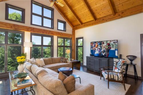 a living room with a couch and a tv at Evergreen Cottage in Blowing Rock