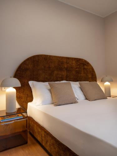 a bedroom with a large white bed with two pillows at Fill's Luxury Design Apartments 100m from the Beach in Rimini