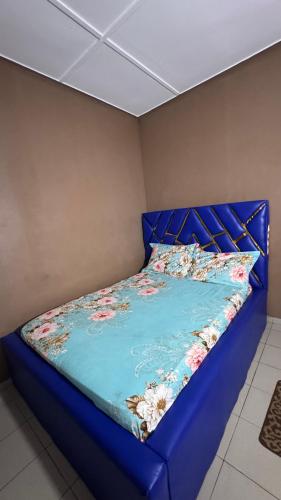 a bed in a room with a blue head board at King Appartement in Lomé