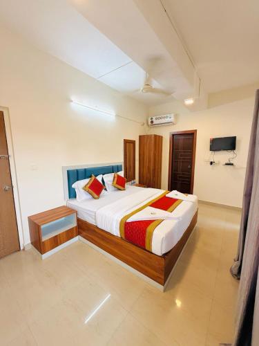 a bedroom with a large bed in a room at Hotel SAI GRAND in Mangalore