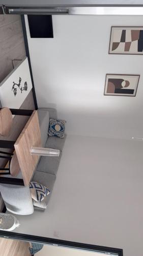 a shelf in a room with pictures on the wall at appartement de 45 m sur cour centre ville de morez in Morez