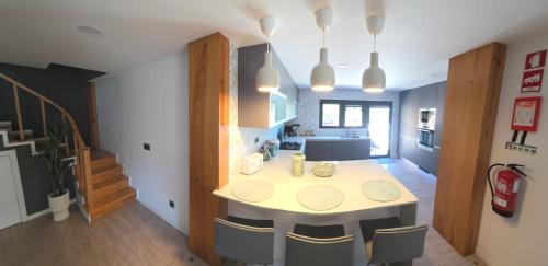 a kitchen with a table and chairs in a room at Casa Sobreira de Mondim in Mondim de Basto