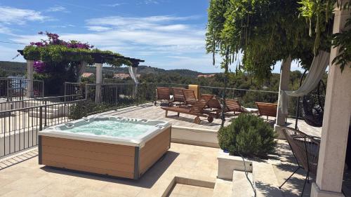 a hot tub sitting on top of a patio at Villa Julia with heated pool and hot tub, ideal for large groups in Milna