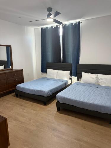 a bedroom with two beds and a dresser at Coral Sands in Seaside Heights