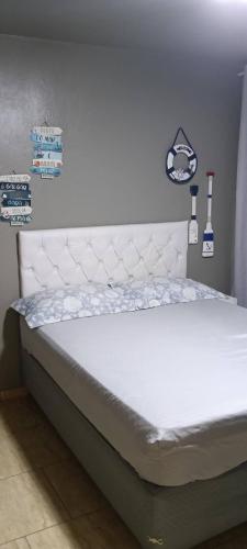 a bed in a bedroom with a white mattress at Verde Mar Abricó 4 in Rio das Ostras