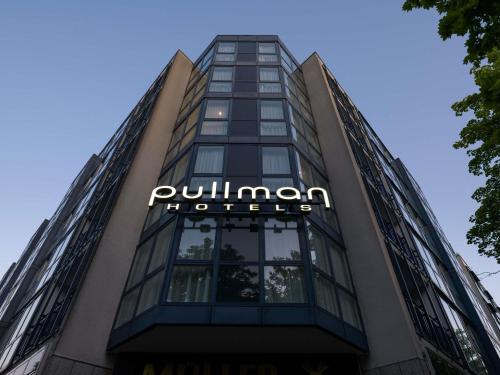 a building with a sign on the side of it at Pullman Munich in Munich