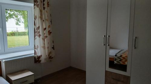 a bedroom with a window and a bed and a curtain at Zgona in Livno