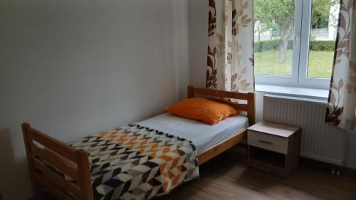 a small bed in a room with a window at Zgona in Livno
