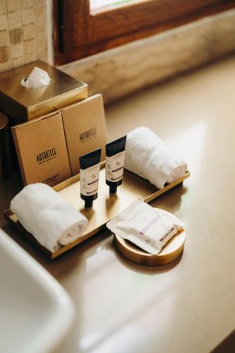 a table with two towels and two boxes on it at Mama Cuchara by Art Hotels in Quito