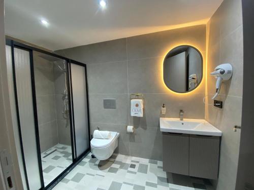 a bathroom with a toilet and a sink and a mirror at Olive House in Pamukkale