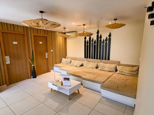 a living room with a couch and a table at Mercure Brignoles Golf de Barbaroux & Spa in Brignoles