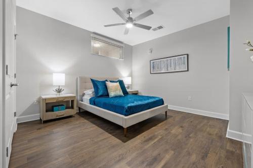 a bedroom with a bed and a ceiling fan at Spacious 2BR N Gulch Walk to Broadway & Rooftops in Nashville