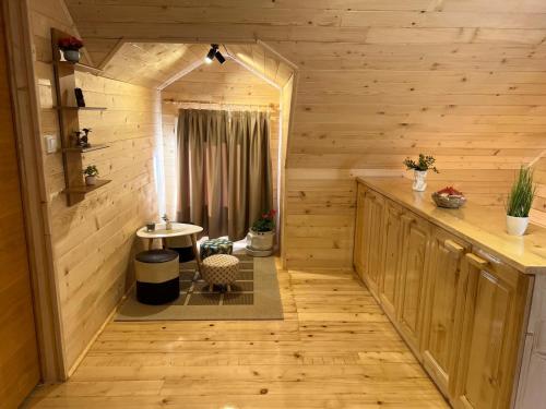an inside view of a log cabin with a small table at Brvnarica na reci in Brus