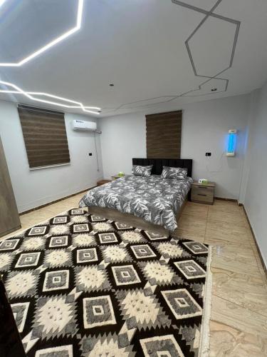 a bedroom with a bed and a rug on the floor at Green forest farm in Ajloun
