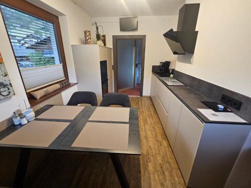a kitchen with a table and a counter top at Appartement Maria Leiter in Sillian