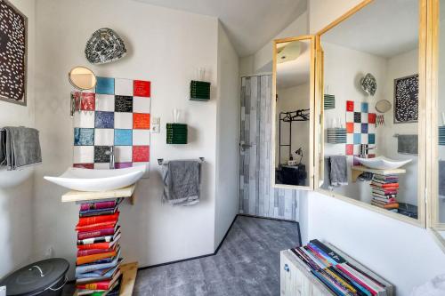 a bathroom with a sink and a mirror at Be my Guest House in Wijk aan Zee