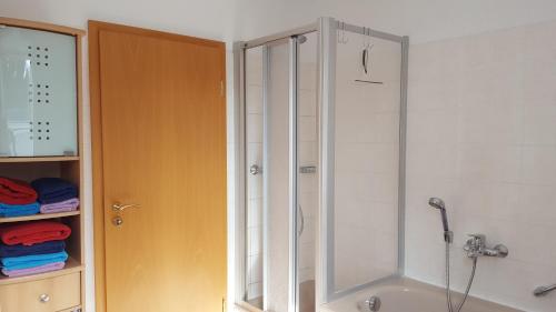 a shower with a glass door in a bathroom at Ferienwohnung Bandow in Woltersdorf