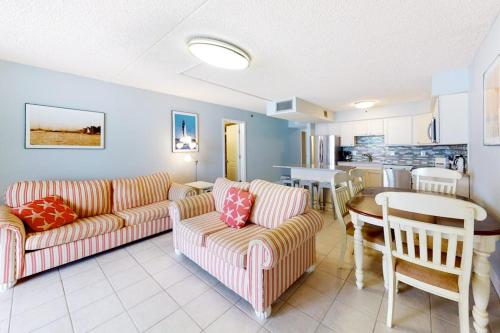 a living room with two couches and a table at Carousel 1904 in Ocean City