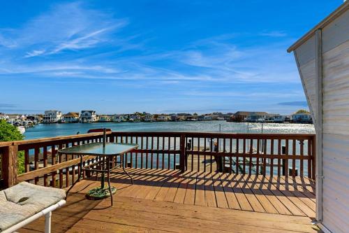 a balcony with a table and a view of the water at Oyster Lane Hideout in Ocean City